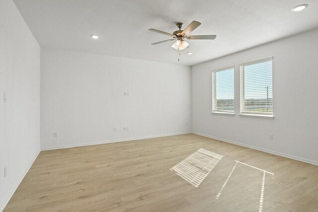 unfurnished room with ceiling fan and light wood-type flooring