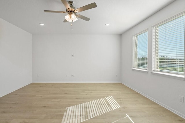 empty room featuring ceiling fan and light hardwood / wood-style floors