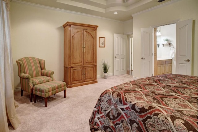 carpeted bedroom featuring a raised ceiling, crown molding, and ensuite bath