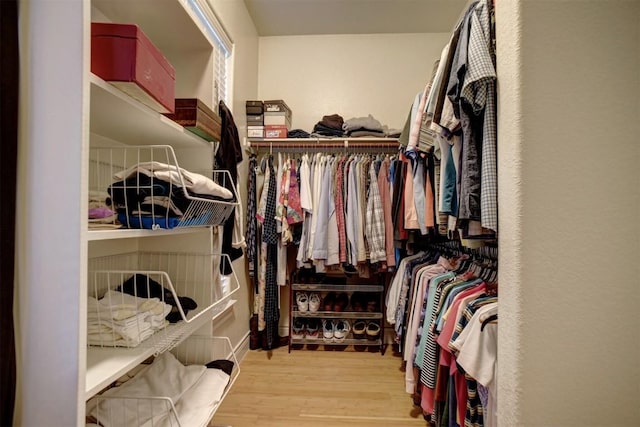 spacious closet with light hardwood / wood-style floors