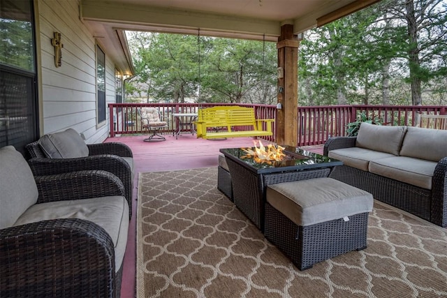 view of patio featuring an outdoor living space with a fire pit and a deck