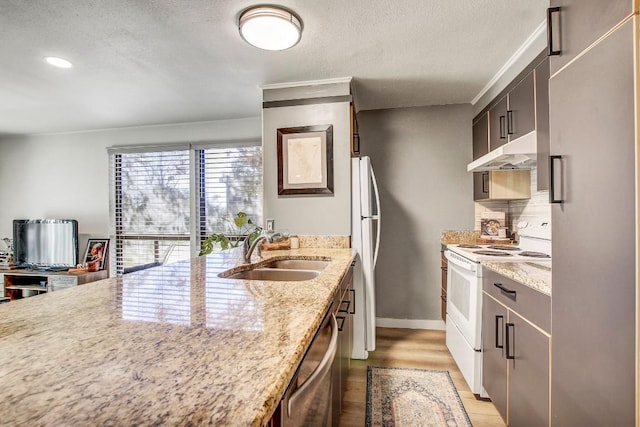 kitchen featuring white appliances, sink, decorative backsplash, light stone countertops, and light wood-type flooring