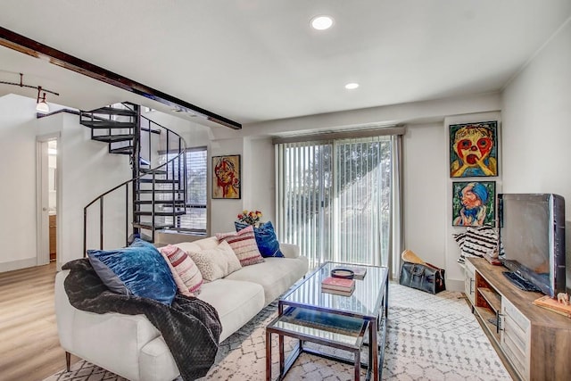 living room with beam ceiling and light wood-type flooring