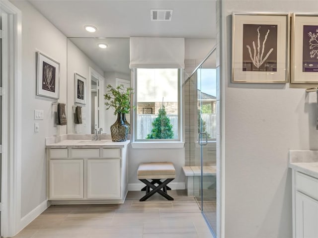 bathroom with vanity, tile patterned floors, and walk in shower