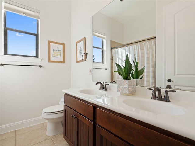 bathroom featuring tile patterned flooring, vanity, toilet, and walk in shower