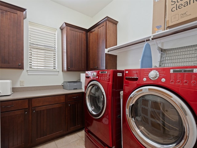 washroom with cabinets, light tile patterned floors, and washing machine and dryer