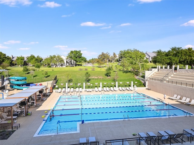 view of pool with a patio area and a water slide