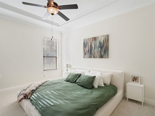 bedroom with carpet, a raised ceiling, ceiling fan, and ornamental molding