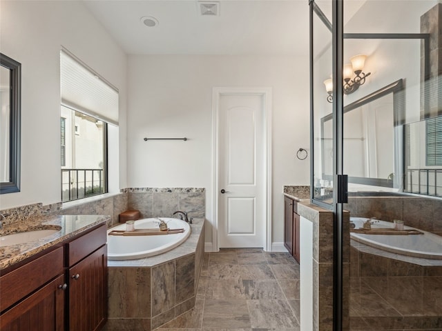 bathroom with separate shower and tub and vanity