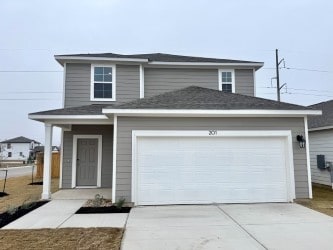 view of property with a garage and covered porch