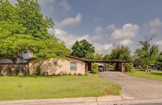 ranch-style home with a front lawn and a carport