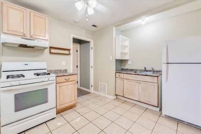 kitchen with light tile patterned flooring, white appliances, light brown cabinetry, and sink