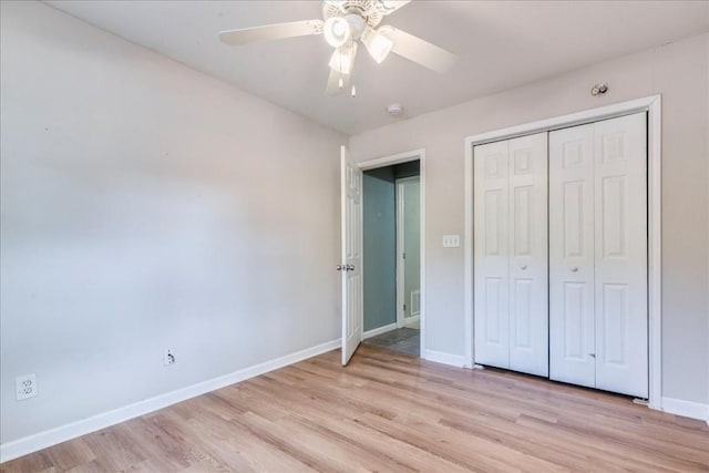 unfurnished bedroom featuring ceiling fan, light hardwood / wood-style floors, and a closet