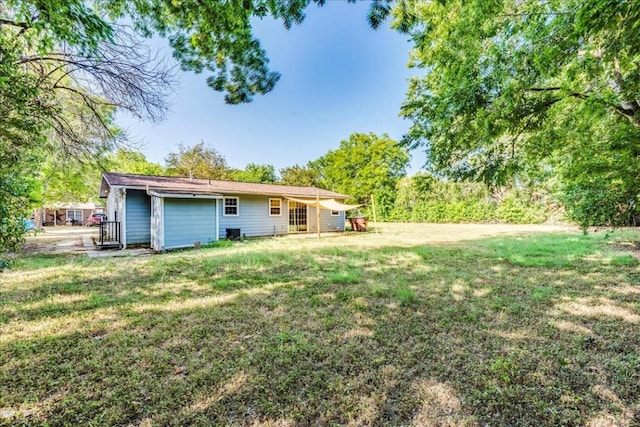 rear view of house with a yard