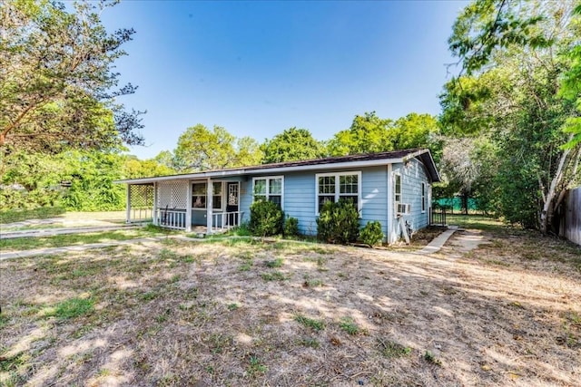 ranch-style home with cooling unit and covered porch