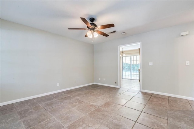 unfurnished room with tile patterned floors and ceiling fan