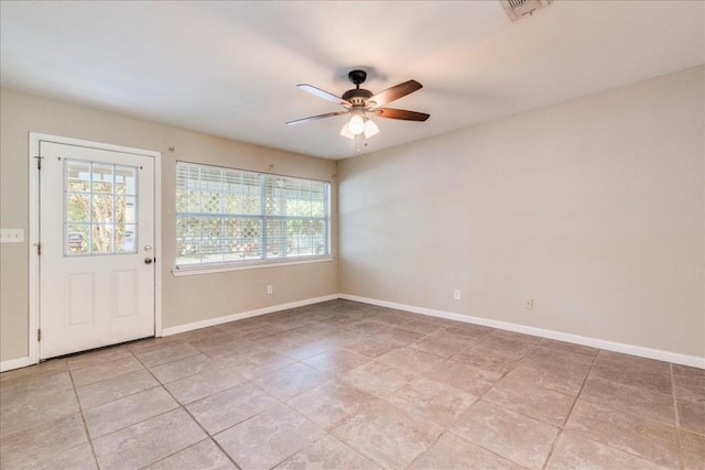 609 Cottonwood St, Lockhart, TX 78644 - unfurnished room with light tile patterned flooring, plenty of natural light, visible vents, and ceiling fan