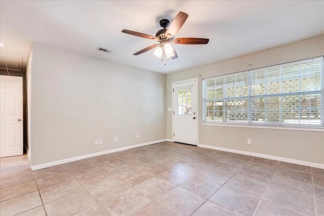 609 Cottonwood St, Lockhart, TX 78644 - spare room featuring attic access, visible vents, a ceiling fan, and baseboards