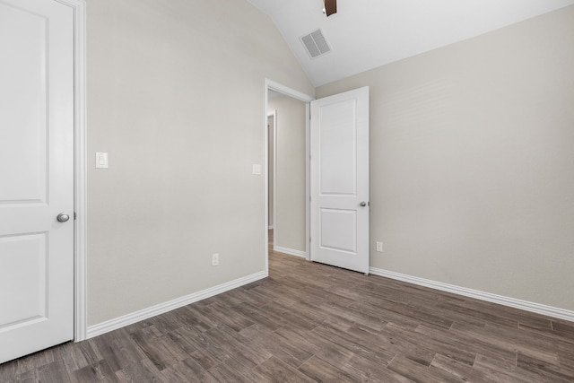 unfurnished bedroom featuring ceiling fan, dark hardwood / wood-style flooring, and vaulted ceiling