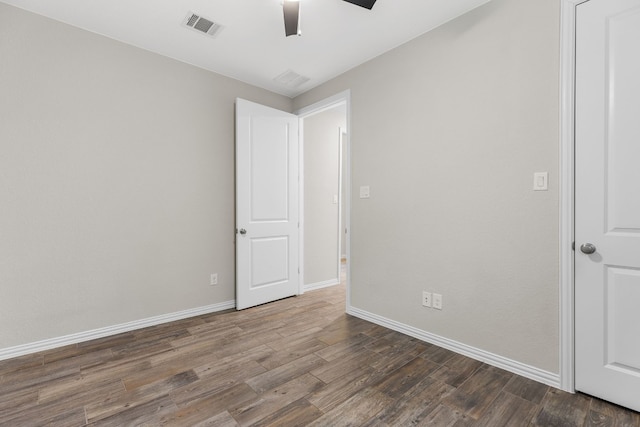 unfurnished room with ceiling fan and wood-type flooring