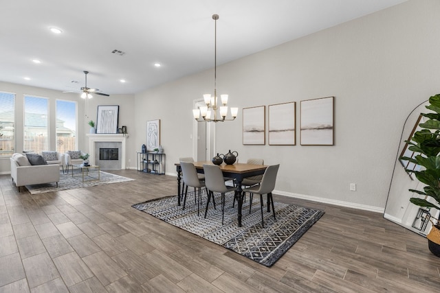 dining room featuring ceiling fan with notable chandelier