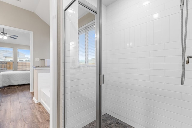 bathroom with hardwood / wood-style floors, ceiling fan, lofted ceiling, and independent shower and bath