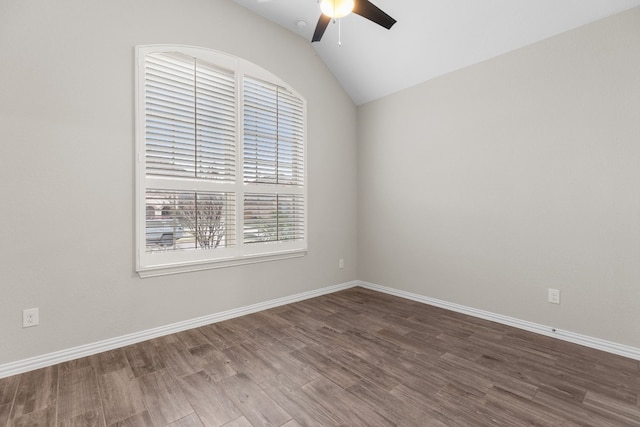 empty room with hardwood / wood-style flooring, vaulted ceiling, and ceiling fan