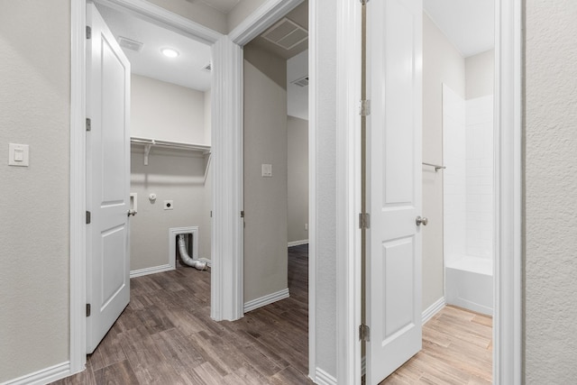 hallway with hardwood / wood-style flooring