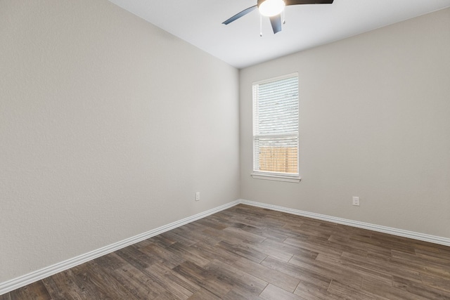 empty room featuring ceiling fan and dark hardwood / wood-style flooring