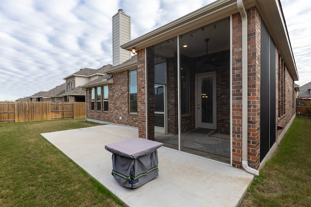 rear view of house with a yard and a patio