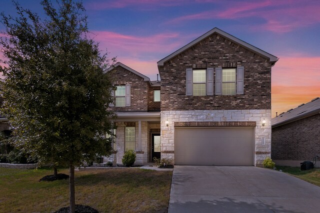 view of front of property featuring a garage and a yard