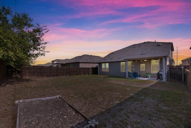 yard at dusk with a patio