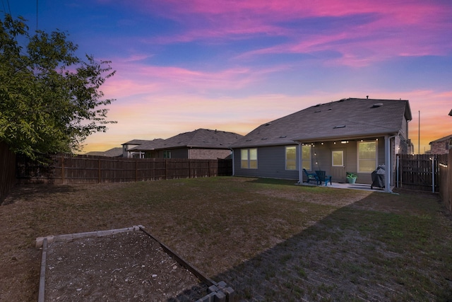 yard at dusk with a patio area