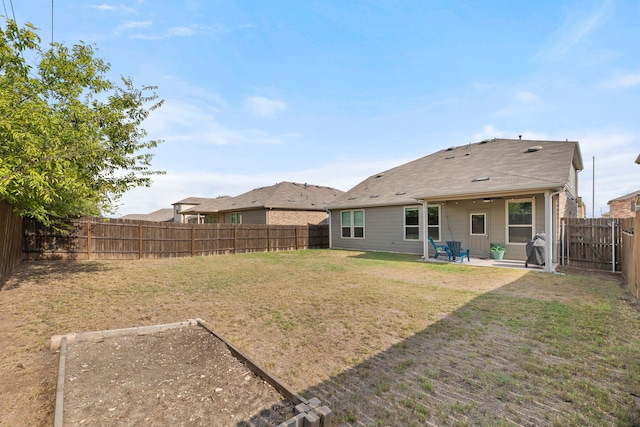 rear view of property with a yard and a patio