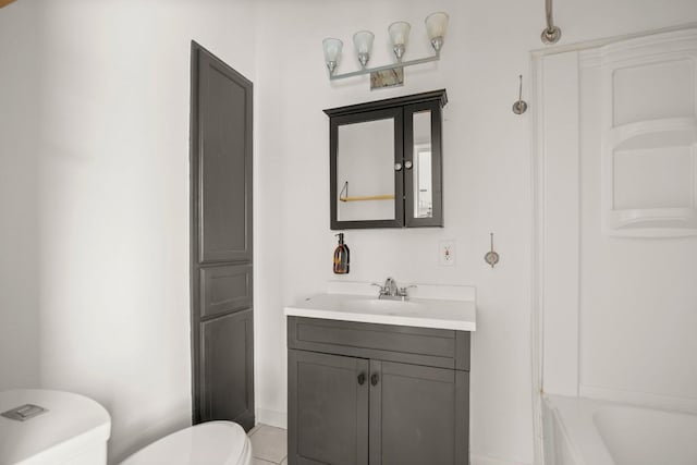 bathroom featuring tile patterned floors, vanity, and toilet