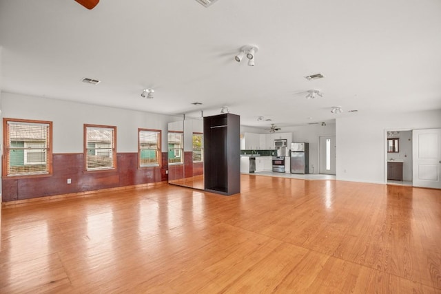 interior space with light hardwood / wood-style flooring and ceiling fan