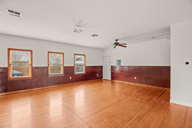 spare room with ceiling fan and light wood-type flooring