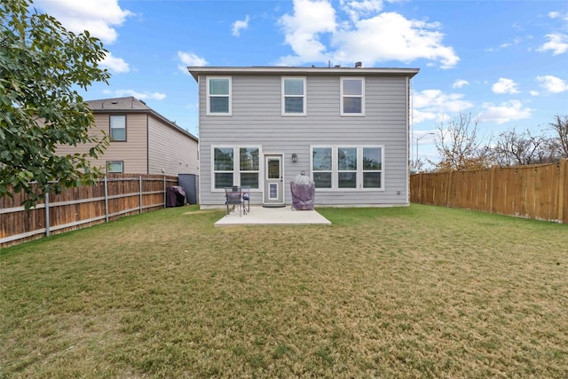 back of house with a yard and a patio