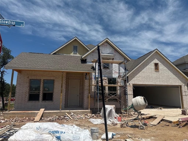 1748 Snowdrop Dr, Georgetown, TX 78628 - property under construction featuring roof with shingles, an attached garage, and brick siding
