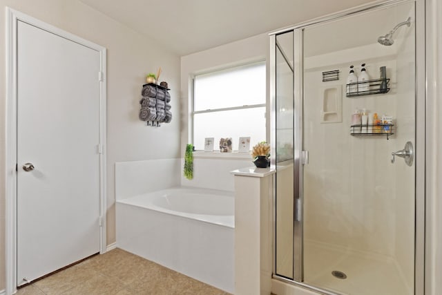 bathroom with tile patterned floors and separate shower and tub