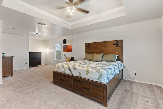 carpeted bedroom featuring a raised ceiling, ceiling fan, and crown molding