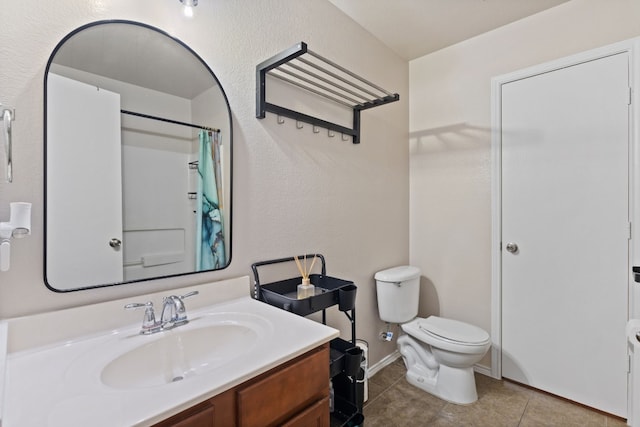 bathroom featuring tile patterned flooring, vanity, toilet, and curtained shower