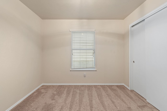 empty room featuring light carpet