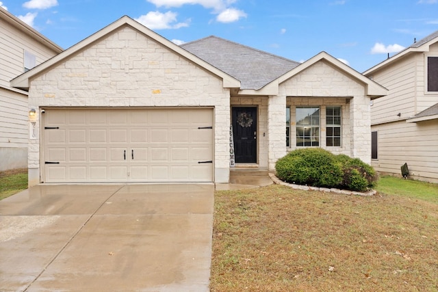 view of front facade featuring a front yard and a garage