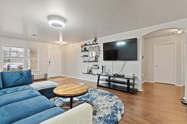 living room featuring hardwood / wood-style flooring and a textured ceiling