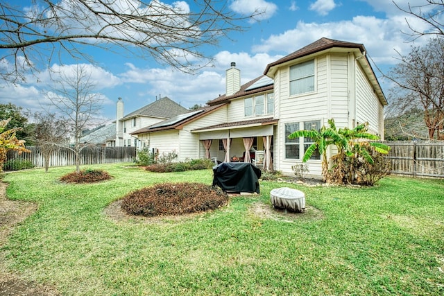 rear view of house with a yard