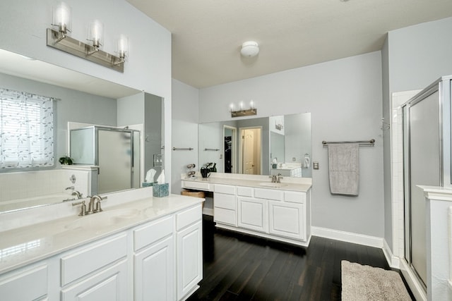 bathroom featuring hardwood / wood-style floors, vanity, and walk in shower