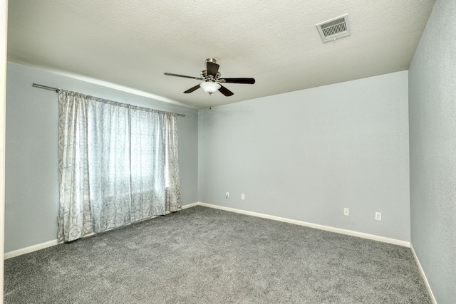 carpeted spare room featuring ceiling fan and a textured ceiling