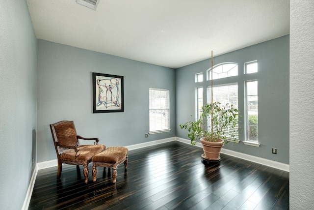 sitting room with dark hardwood / wood-style flooring