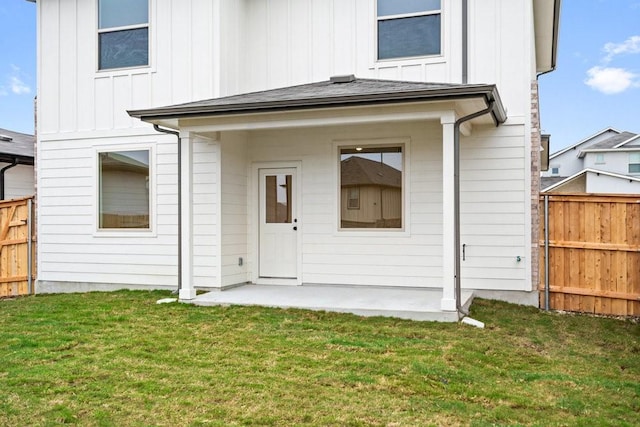 rear view of house with a patio area and a yard